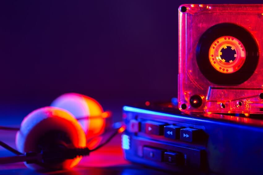 90s party invitation: cassette tape player and headphones on a table