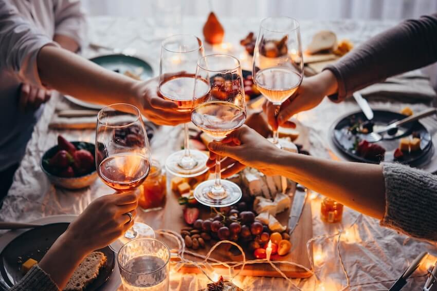 Fall birthday party ideas: people clinking their wine glasses