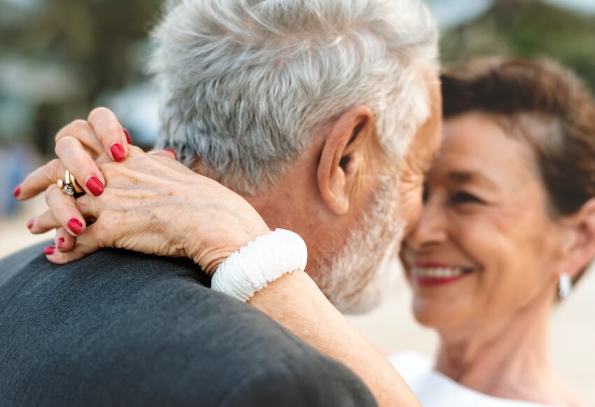 55th wedding anniversary: senior couple smiling at each other while dancing
