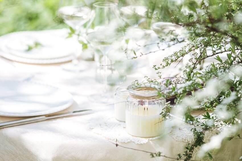 Eco wedding: table setting with candles in glass jars